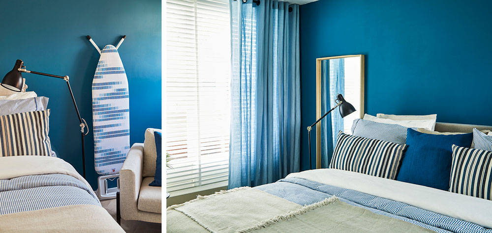 slaapkamer met blauwe achterwand met brabantia strijkplank